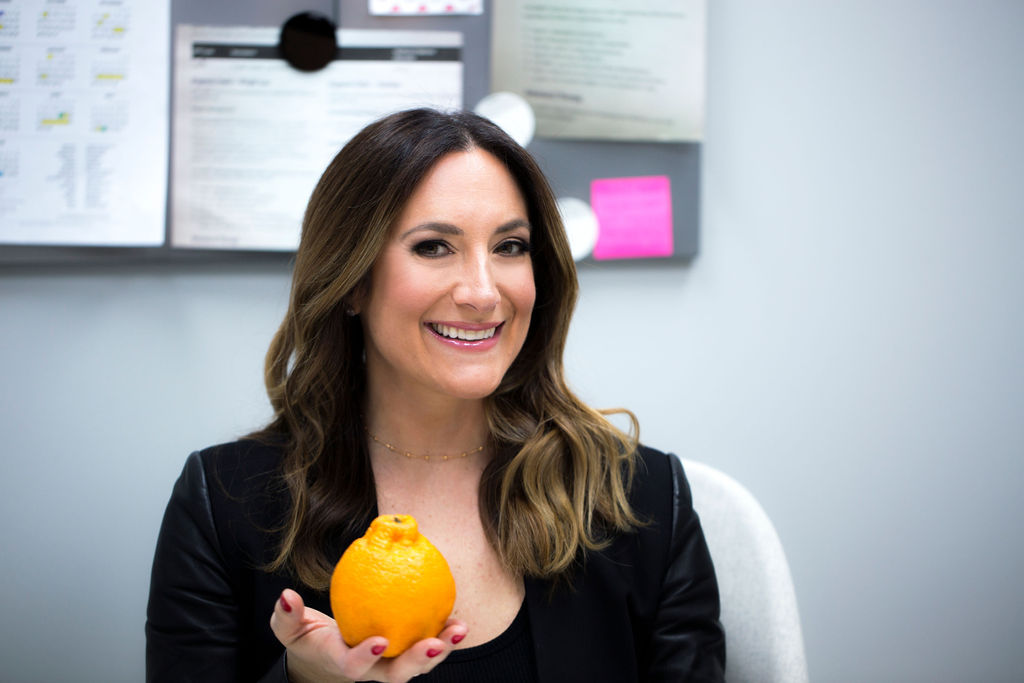 Laura holding orange